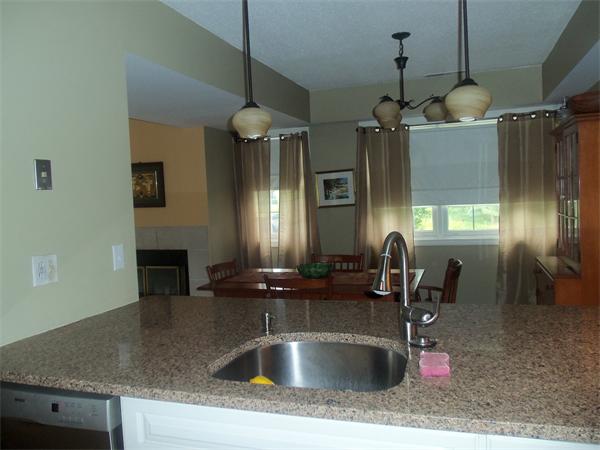 16 Canvasback Way, Unit 16 Walpole, MA 02081 - Photo 8 of 30 a kitchen with kitchen island a sink stainless steel appliances and a counter top space
