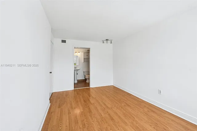 a room with a wooden floor and window