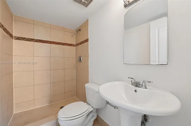 a bathroom with a toilet and shower