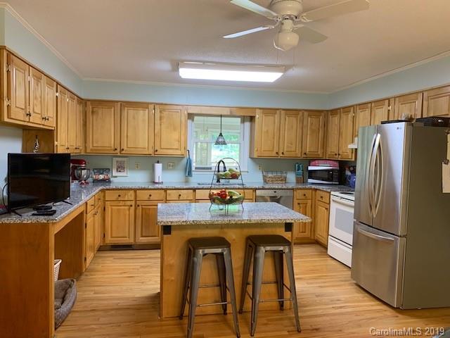 319 Happy Valley Road Union, SC 29379 - Photo 2 of 6 a kitchen with a refrigerator a microwave a sink and cabinets