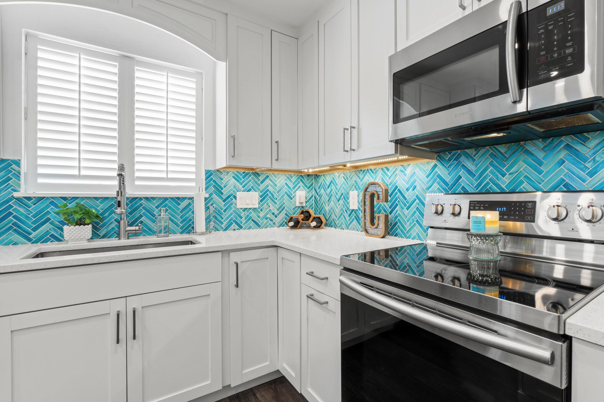 130 Durango Road, Unit 104 Destin, FL 32541 - Photo 12 of 46 a kitchen with stainless steel appliances white cabinets and a stove