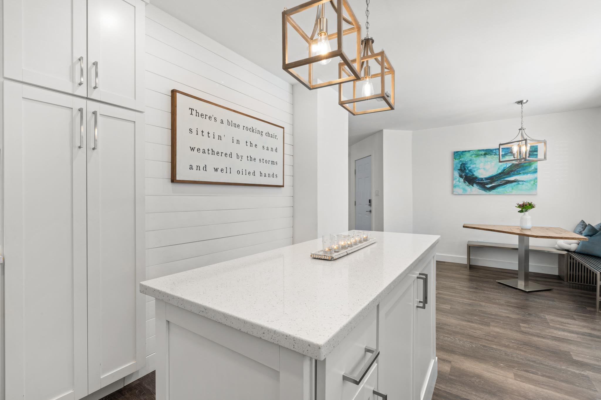 130 Durango Road, Unit 104 Destin, FL 32541 - Photo 13 of 46 a view of kitchen island with cabinets and wooden floor