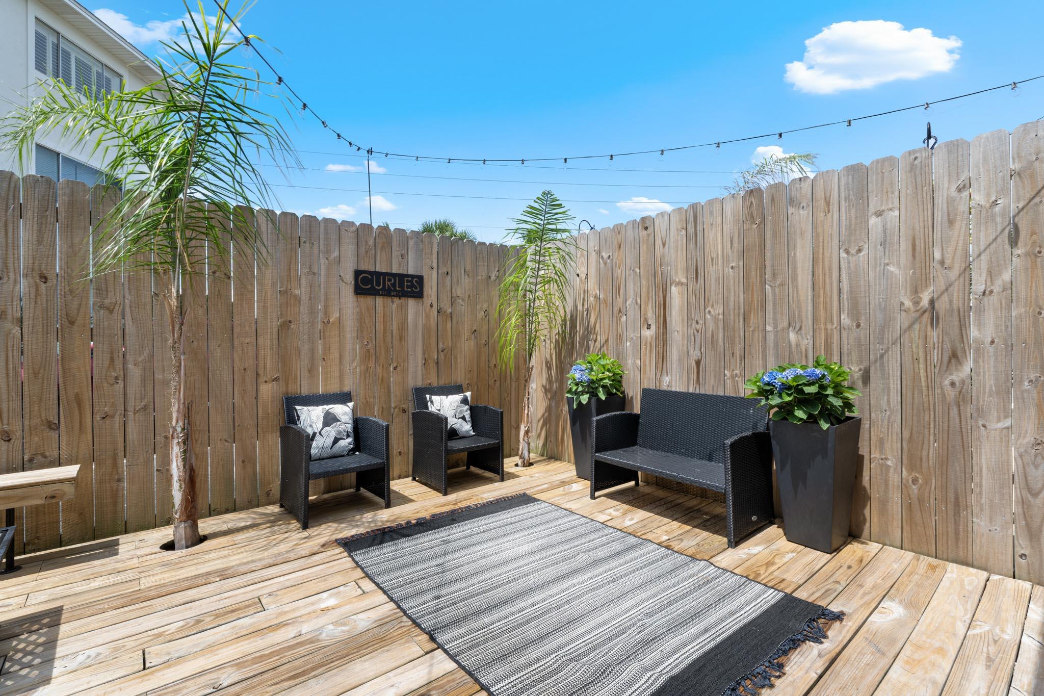 130 Durango Road, Unit 104 Destin, FL 32541 - Photo 18 of 46 a backyard of a house with potted plants and outdoor seating