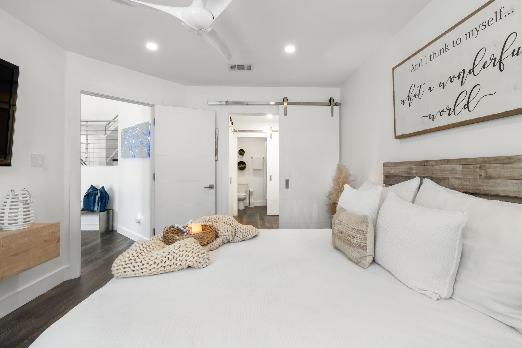 130 Durango Road, Unit 104 Destin, FL 32541 - Photo 27 of 46 a bedroom with a large bed and a couch