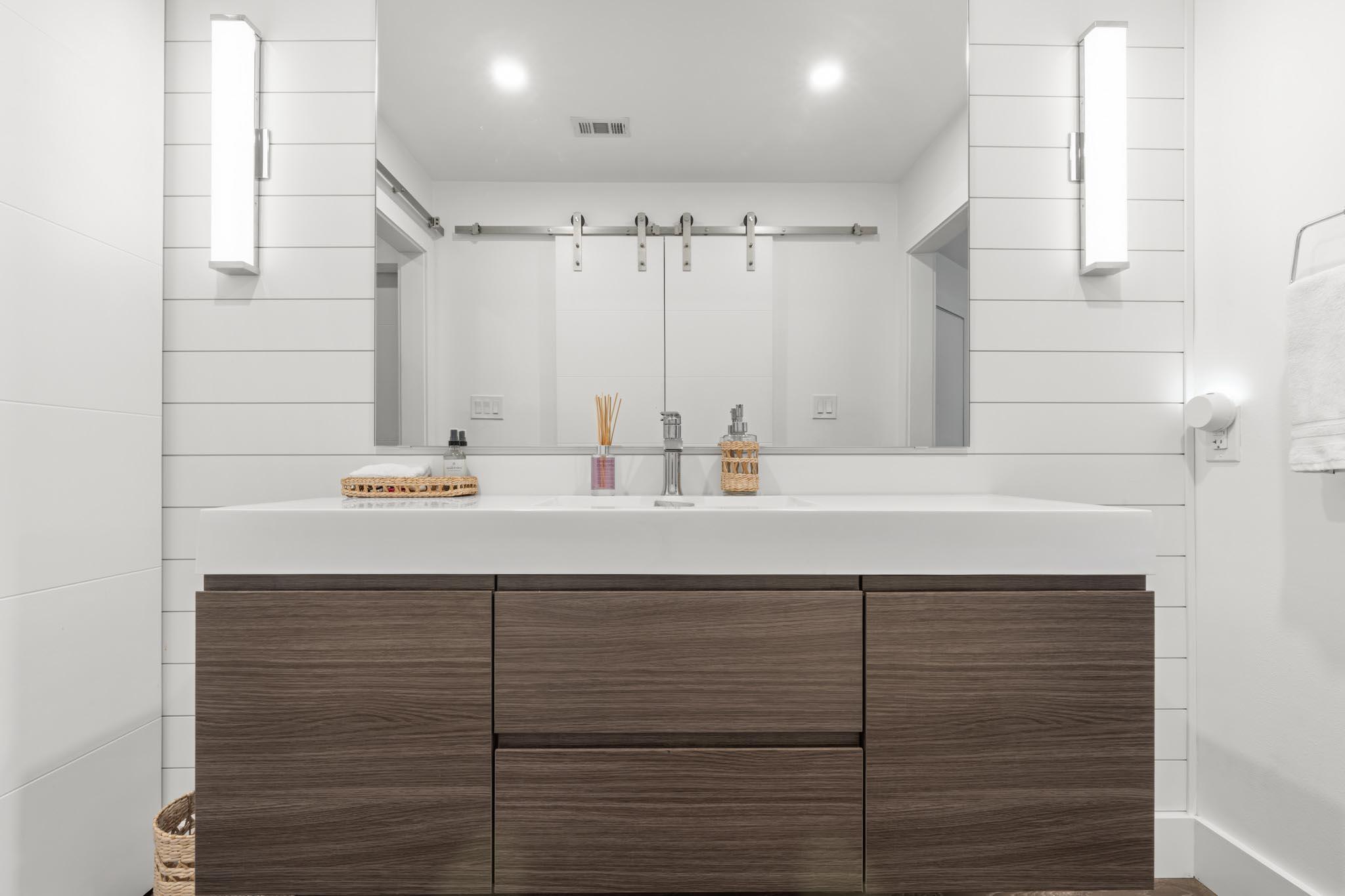 130 Durango Road, Unit 104 Destin, FL 32541 - Photo 30 of 46 a bathroom with a sink and a mirror