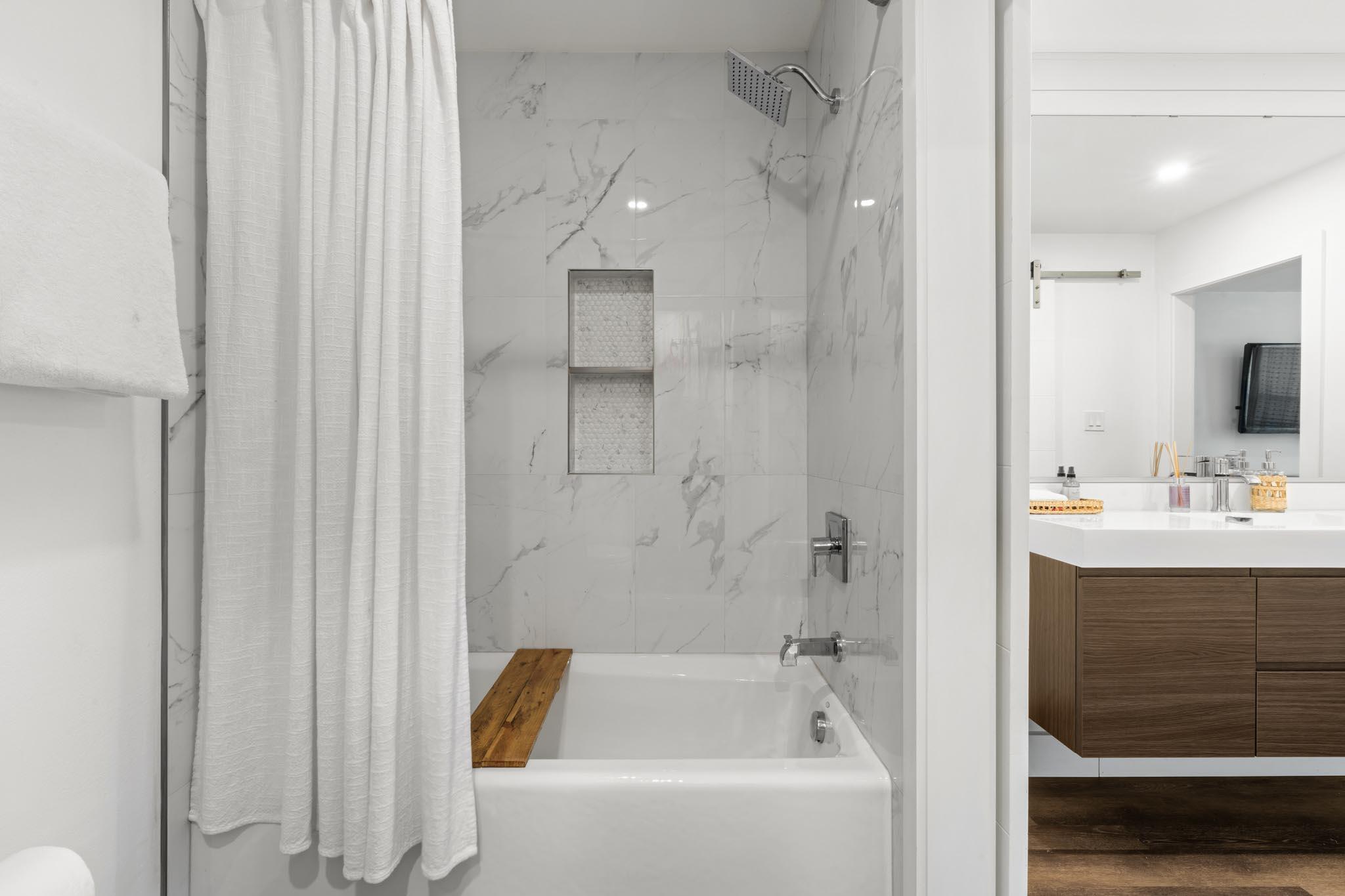 130 Durango Road, Unit 104 Destin, FL 32541 - Photo 31 of 46 a bathroom with a tub sink shower and mirror