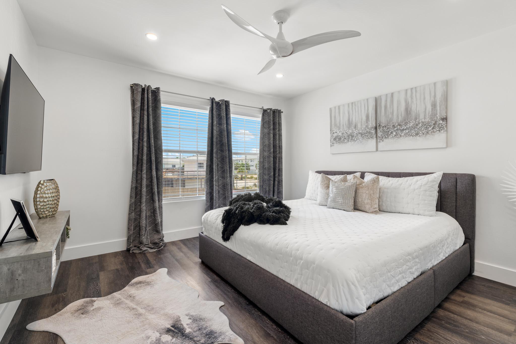 130 Durango Road, Unit 104 Destin, FL 32541 - Photo 34 of 46 a bedroom with a large bed and a large window