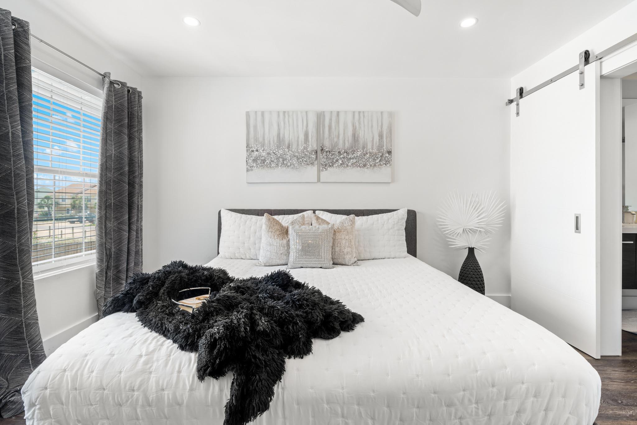 130 Durango Road, Unit 104 Destin, FL 32541 - Photo 35 of 46 a bedroom with a bed window and a wall painting