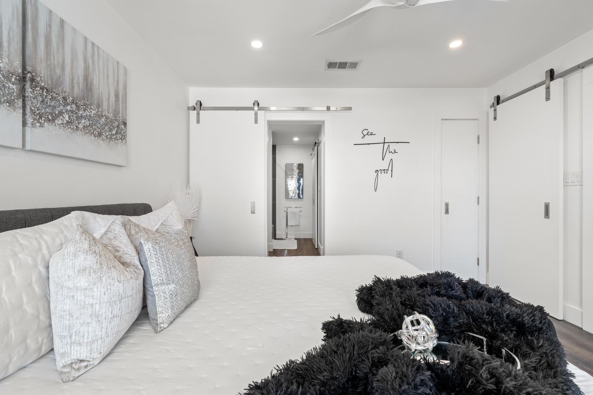 130 Durango Road, Unit 104 Destin, FL 32541 - Photo 37 of 46 a bedroom with a bed and a mirror