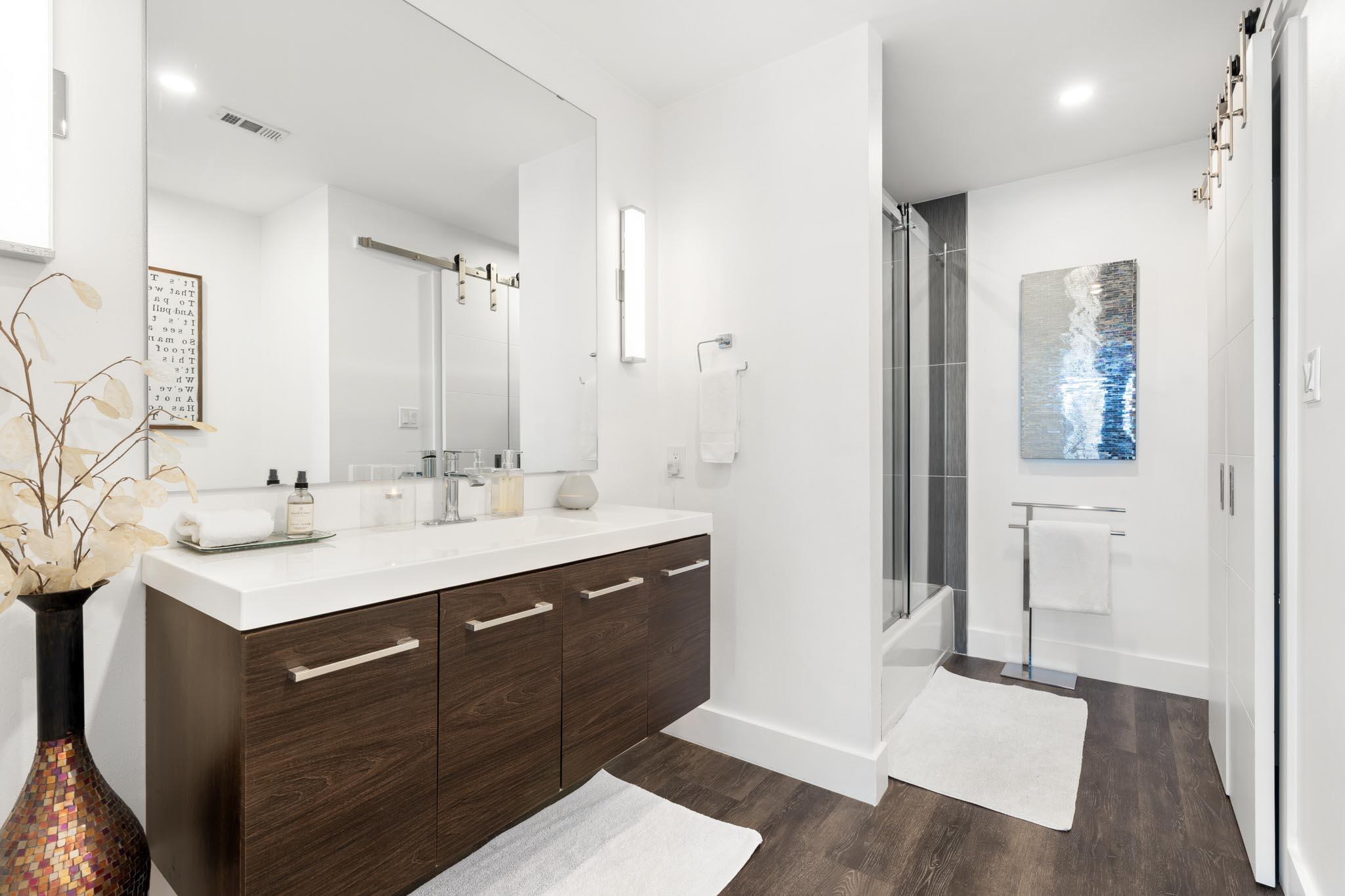 130 Durango Road, Unit 104 Destin, FL 32541 - Photo 38 of 46 a bathroom with a sink a mirror and a shower