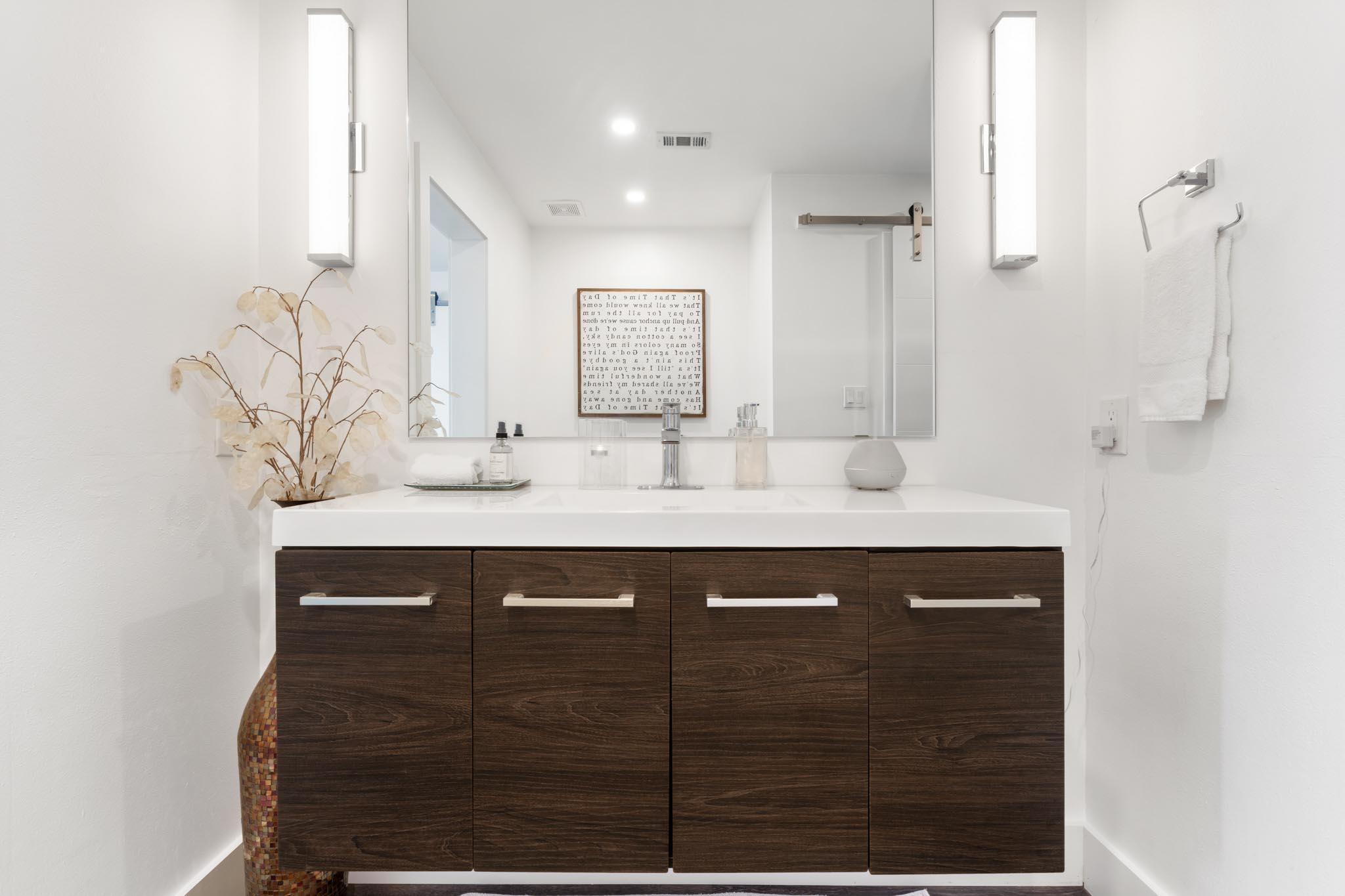 130 Durango Road, Unit 104 Destin, FL 32541 - Photo 40 of 46 a bathroom with a sink and a mirror