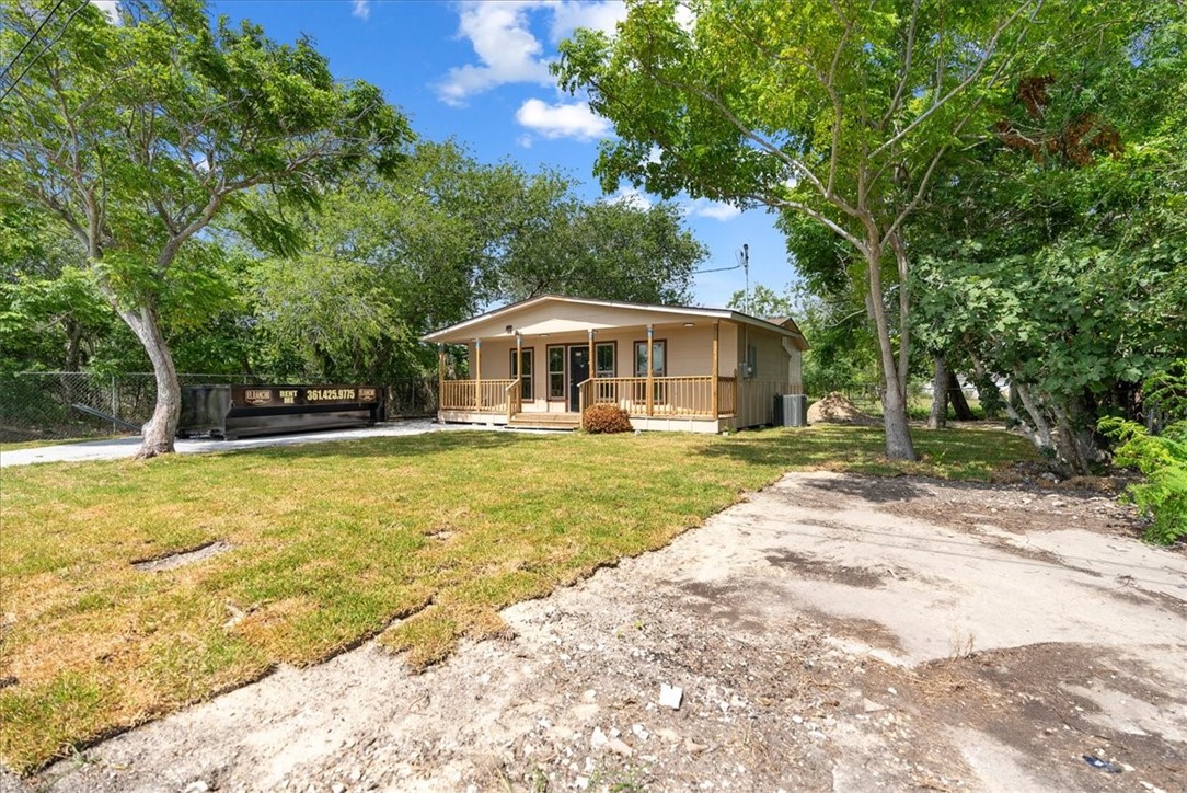 a view of house with swimming pool and trees in the background