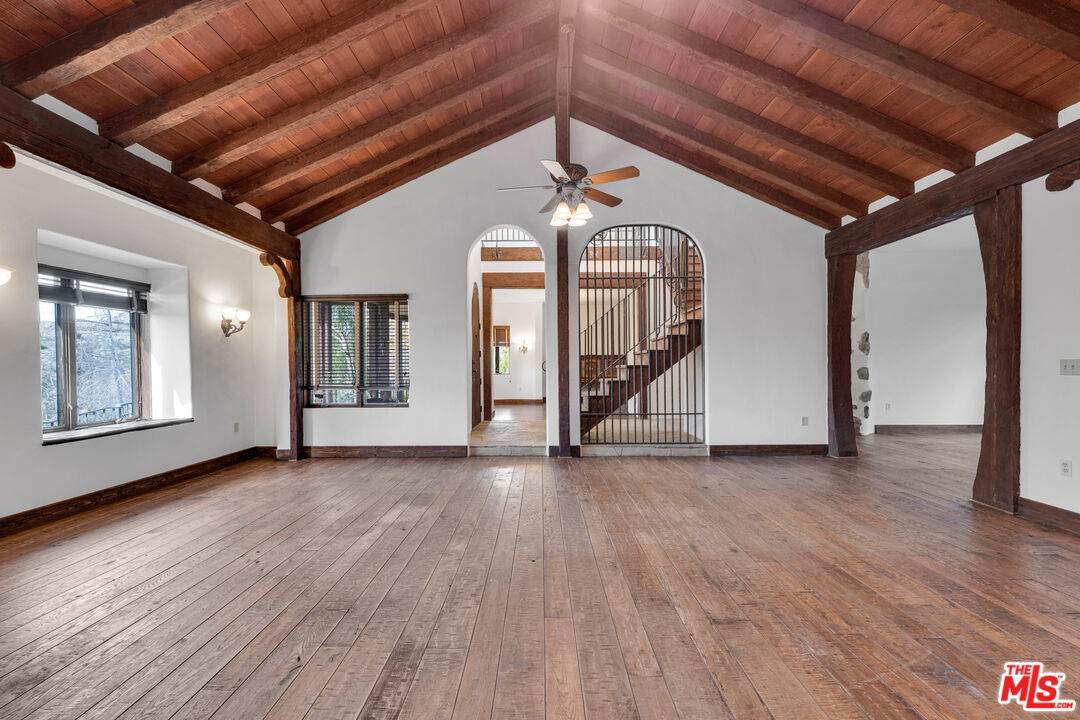 32140 Windrush Road Agua Dulce, CA 91390 - Photo 11 of 41 a view of empty room with wooden floor and fan