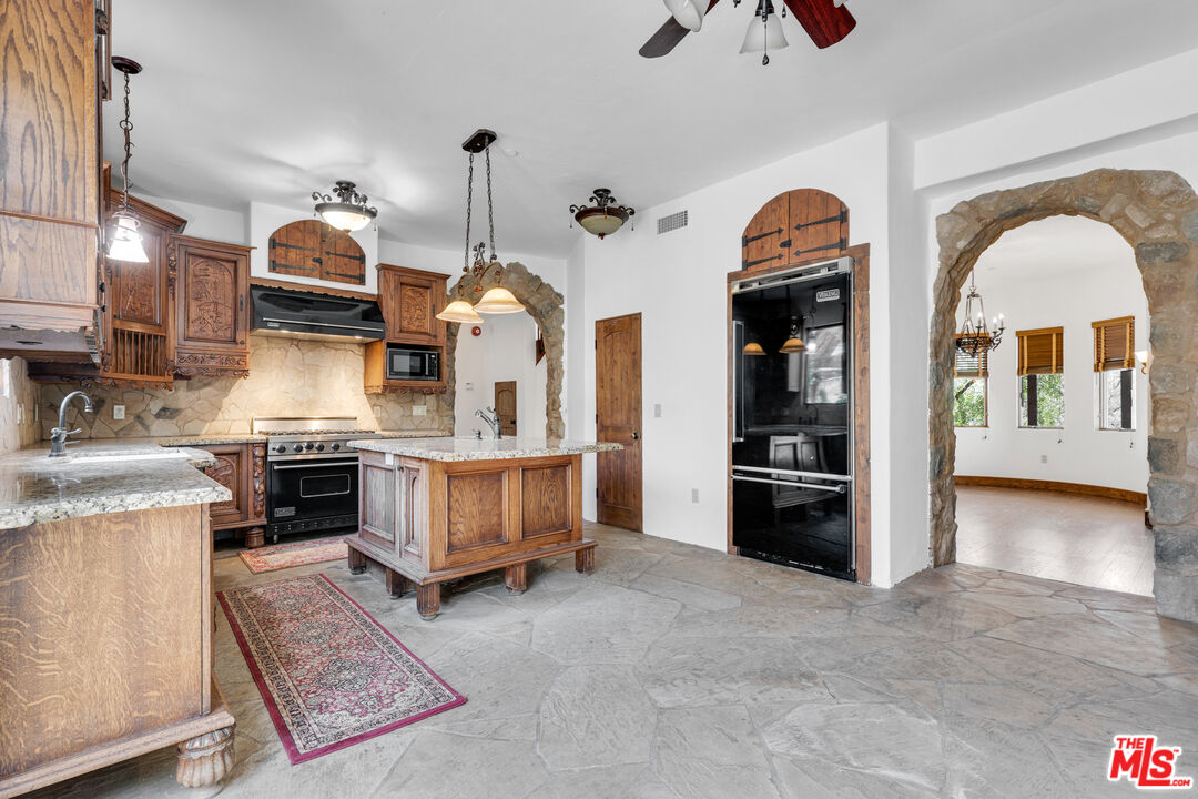 32140 Windrush Road Agua Dulce, CA 91390 - Photo 15 of 41 a kitchen with stainless steel appliances granite countertop a stove and a refrigerator