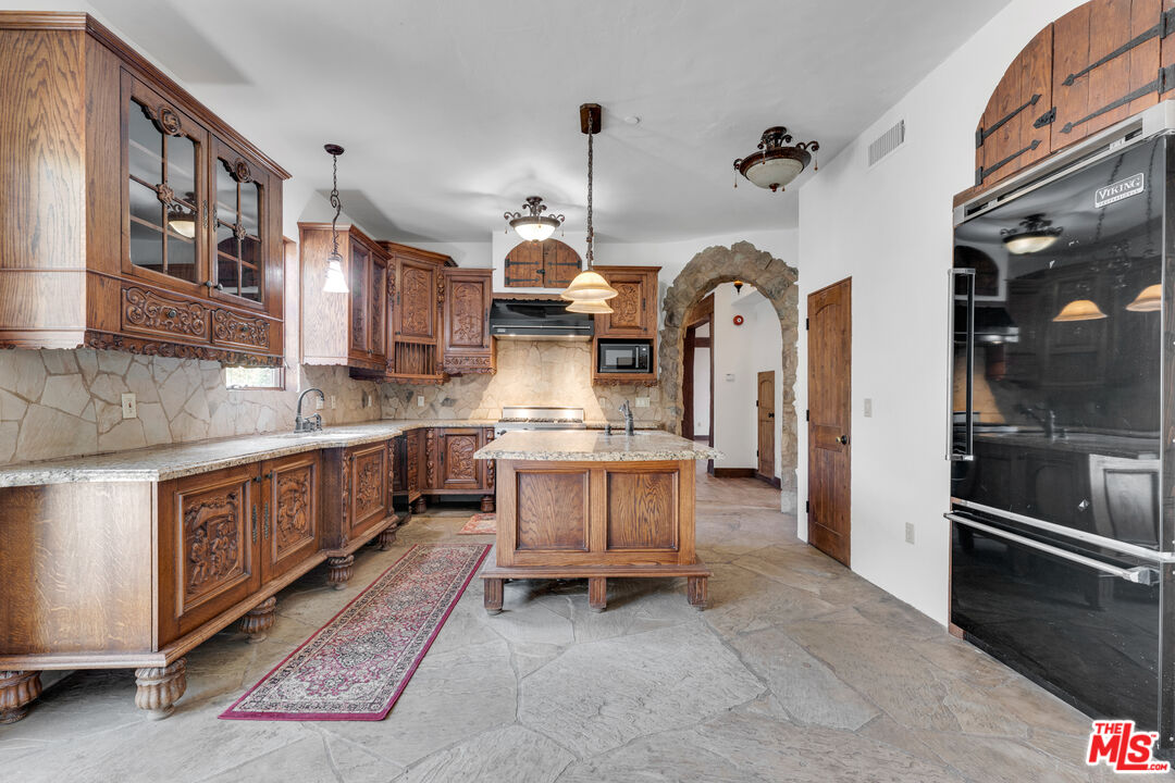 32140 Windrush Road Agua Dulce, CA 91390 - Photo 16 of 41 a kitchen with stainless steel appliances granite countertop a stove a sink and a refrigerator