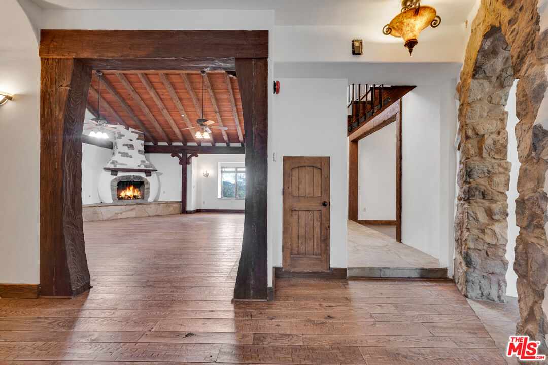 32140 Windrush Road Agua Dulce, CA 91390 - Photo 19 of 41 a view of a hallway with wooden floor and a living room