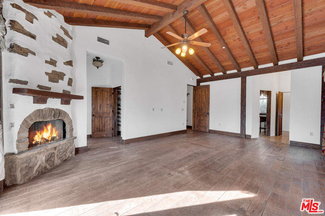 32140 Windrush Road Agua Dulce, CA 91390 - Photo 20 of 41 a view of empty room with fireplace and fan