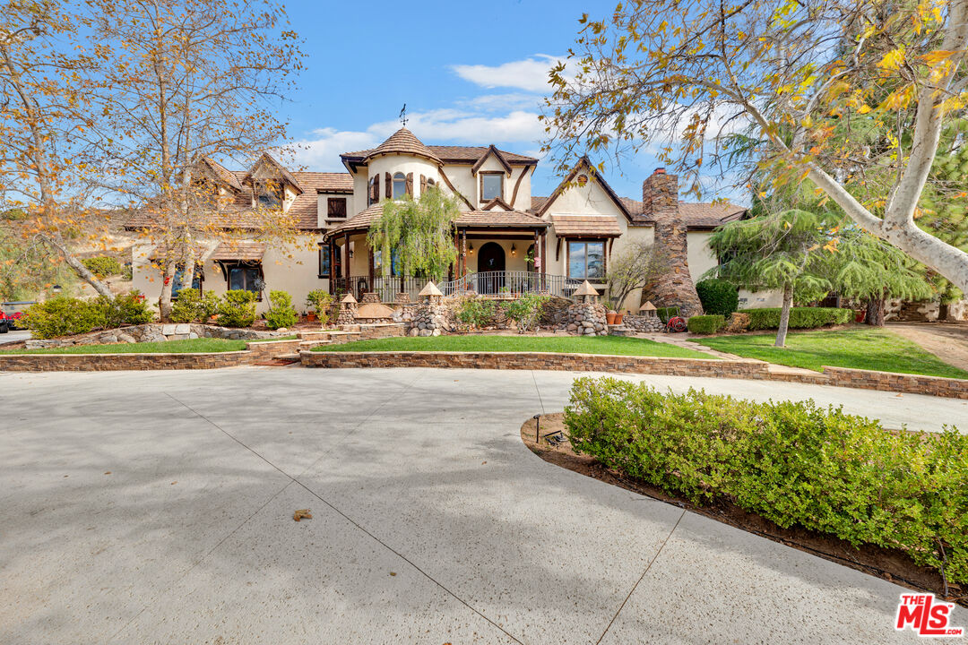 32140 Windrush Road Agua Dulce, CA 91390 - Photo 2 of 41 a front view of a building with a garden and trees