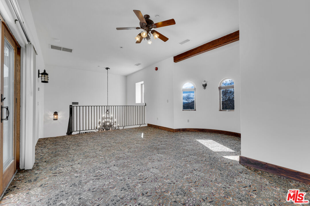 32140 Windrush Road Agua Dulce, CA 91390 - Photo 28 of 41 an empty room with ceiling fan and window