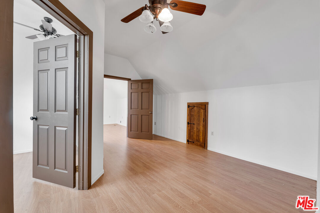 32140 Windrush Road Agua Dulce, CA 91390 - Photo 30 of 41 a view of a hallway with wooden floor and chandelier
