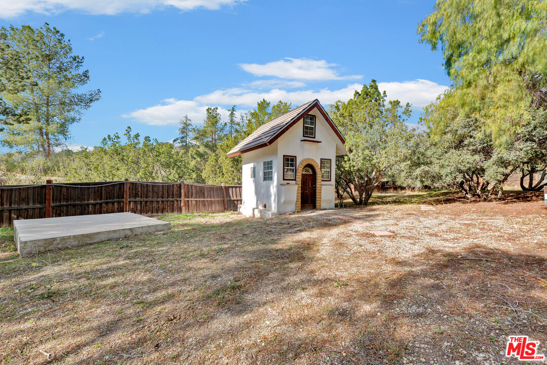 32140 Windrush Road Agua Dulce, CA 91390 - Photo 36 of 41 a view of a house with a yard and garage