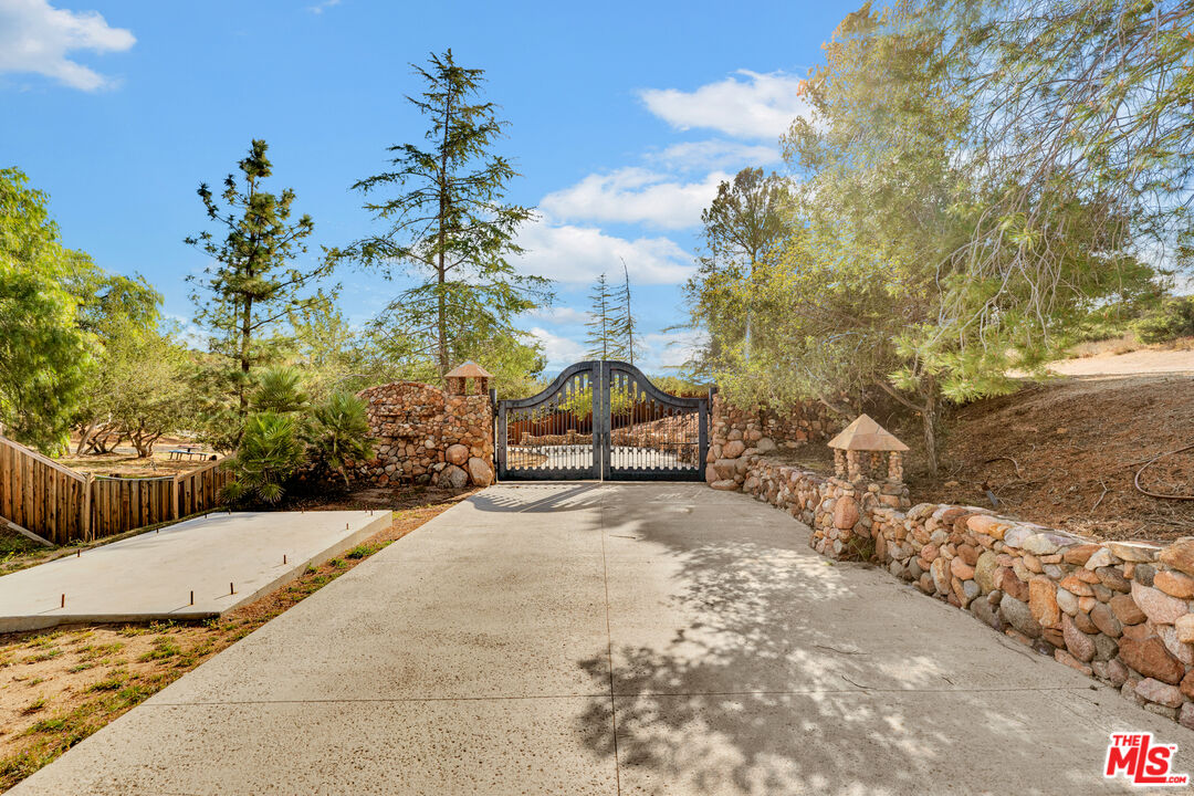32140 Windrush Road Agua Dulce, CA 91390 - Photo 6 of 41 a view of a yard with plants and trees