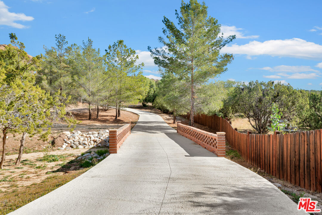 32140 Windrush Road Agua Dulce, CA 91390 - Photo 7 of 41 a view of a swimming pool with a patio