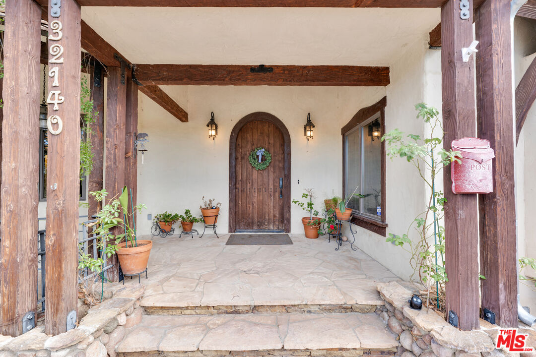 32140 Windrush Road Agua Dulce, CA 91390 - Photo 9 of 41 a front view of a house with outdoor seating
