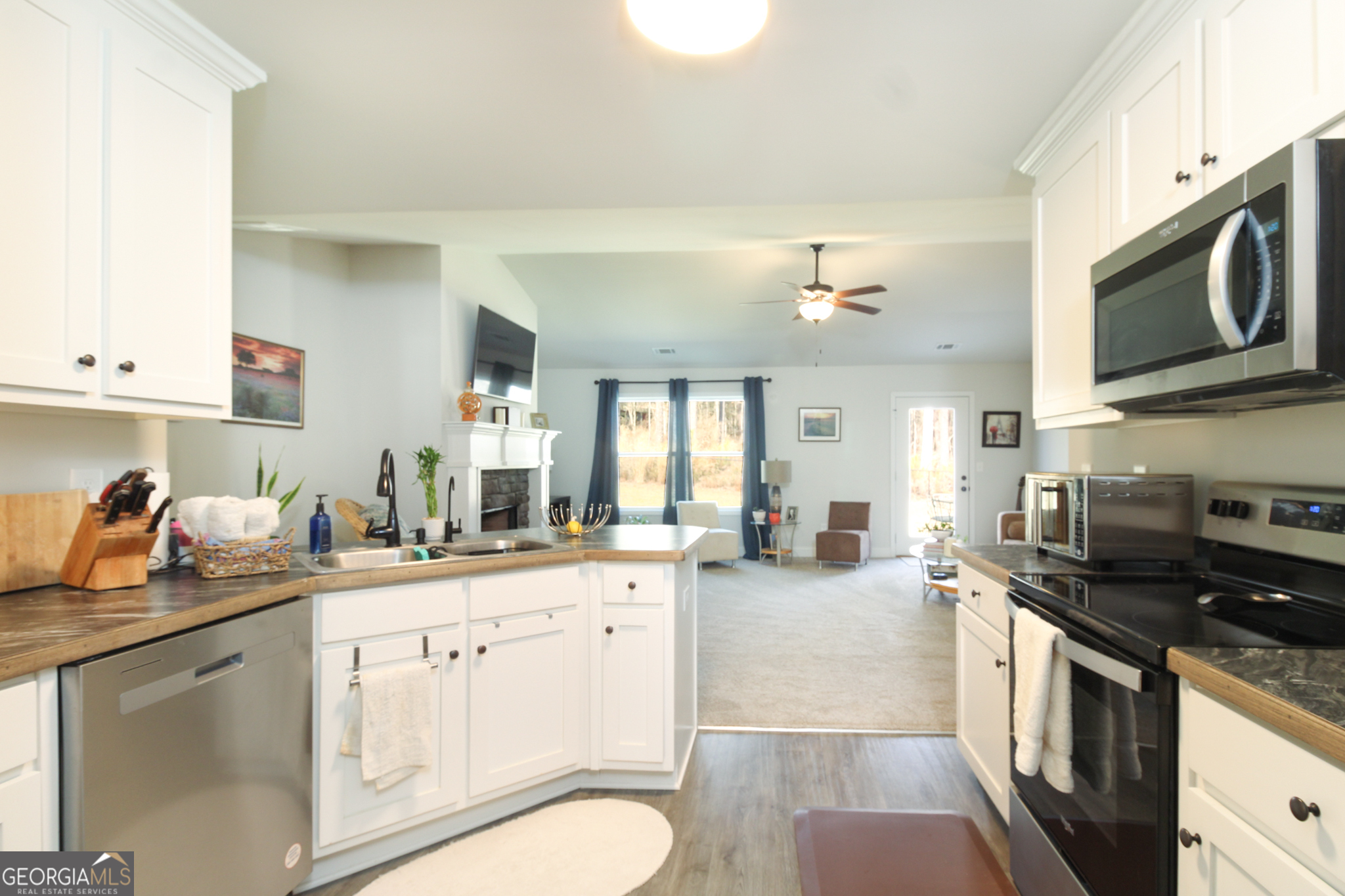31 Rolling Woods Lane Colbert, GA 30628 - Photo 11 of 30 a kitchen with a sink stove and cabinets