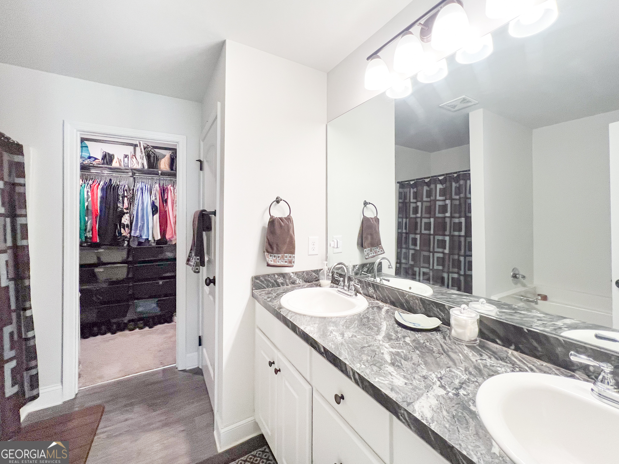 31 Rolling Woods Lane Colbert, GA 30628 - Photo 22 of 30 a bathroom with a granite countertop double vanity sink and a mirror