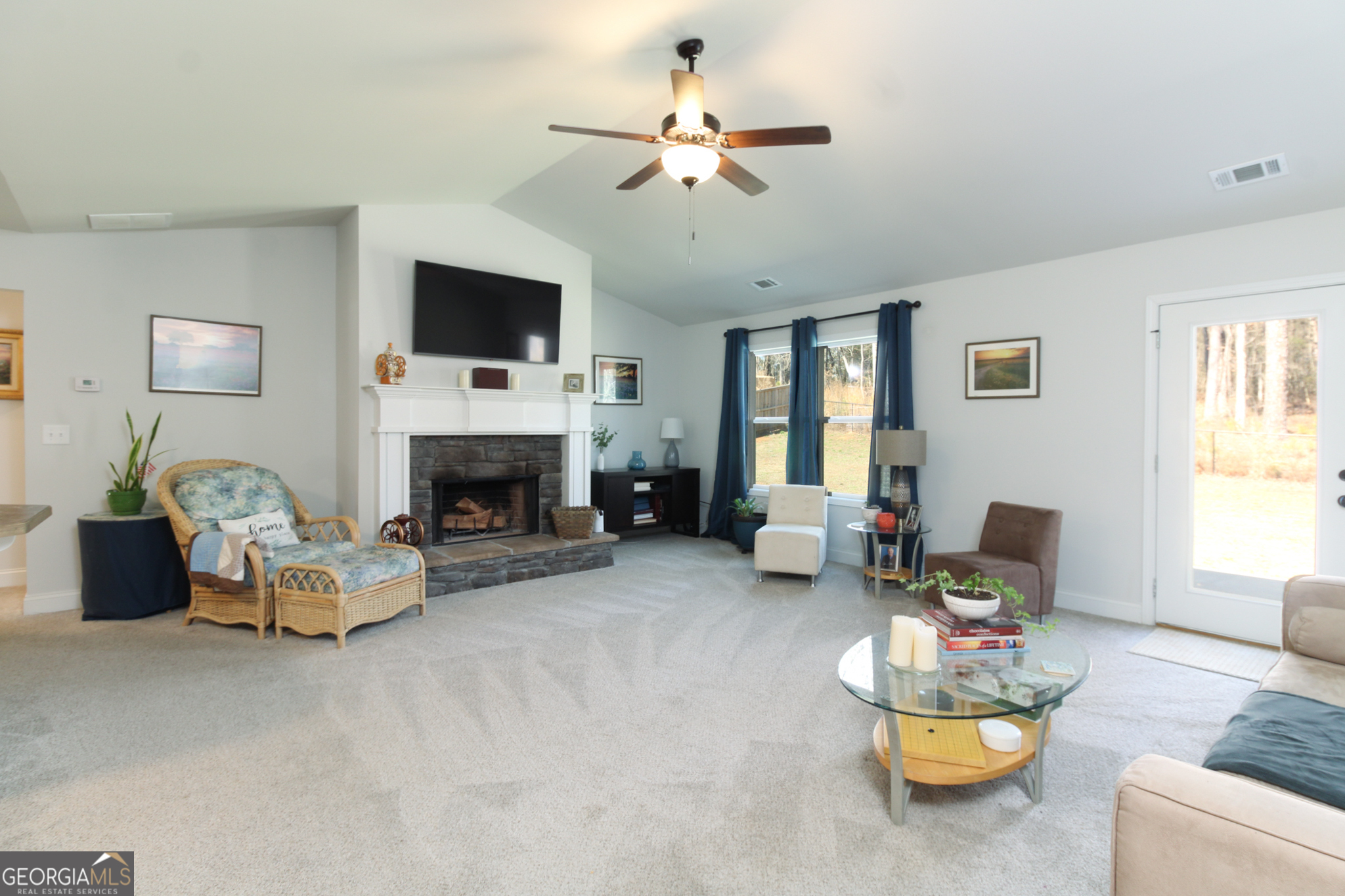 31 Rolling Woods Lane Colbert, GA 30628 - Photo 7 of 30 a living room with furniture fireplace and a flat screen tv
