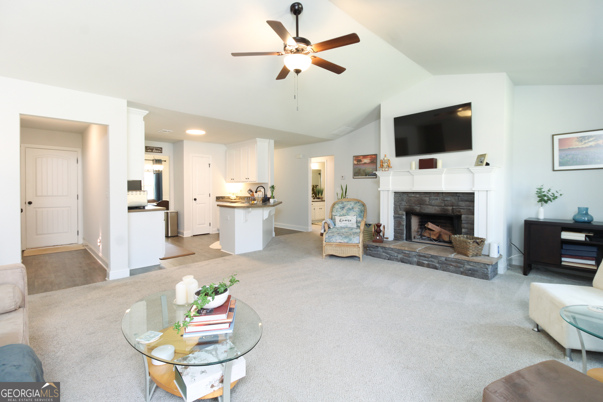 31 Rolling Woods Lane Colbert, GA 30628 - Photo 8 of 30 a living room with furniture a fireplace and a flat screen tv