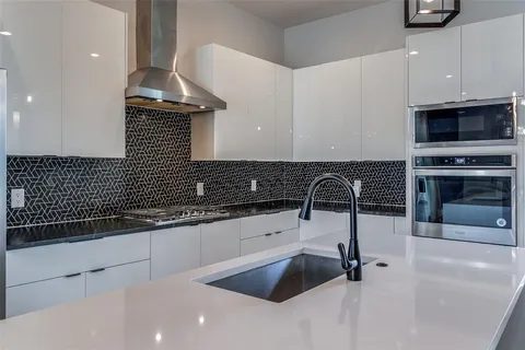 a kitchen with a sink and a stove top oven