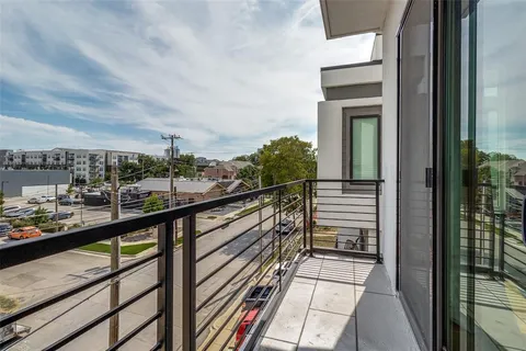 a view of a balcony with wooden floor and fence