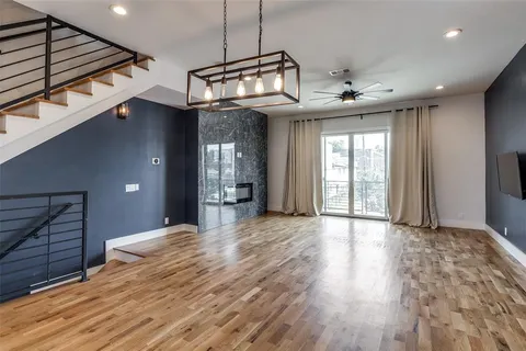 a view of a room with a window and wooden floor