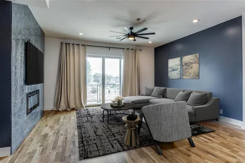 a living room with furniture fireplace and flat screen tv