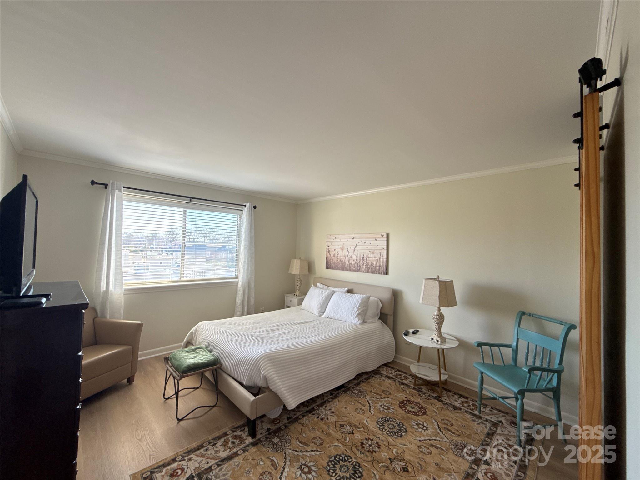 1323 Queens Road, Unit 322 Charlotte, NC 28207 - Photo 14 of 22 a bedroom with a bed and a window