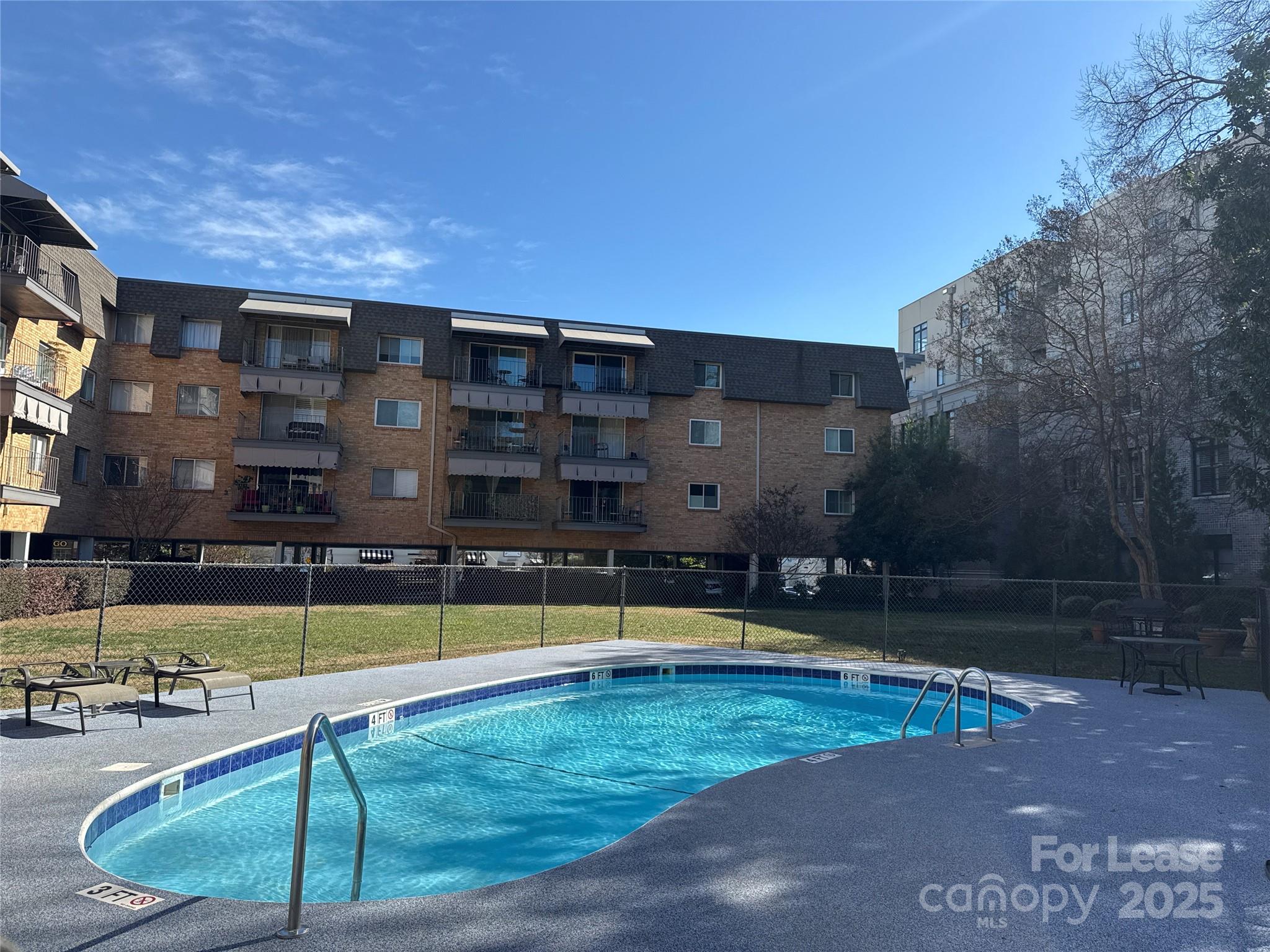1323 Queens Road, Unit 322 Charlotte, NC 28207 - Photo 21 of 22 a view of a swimming pool with an outdoor space and seating area