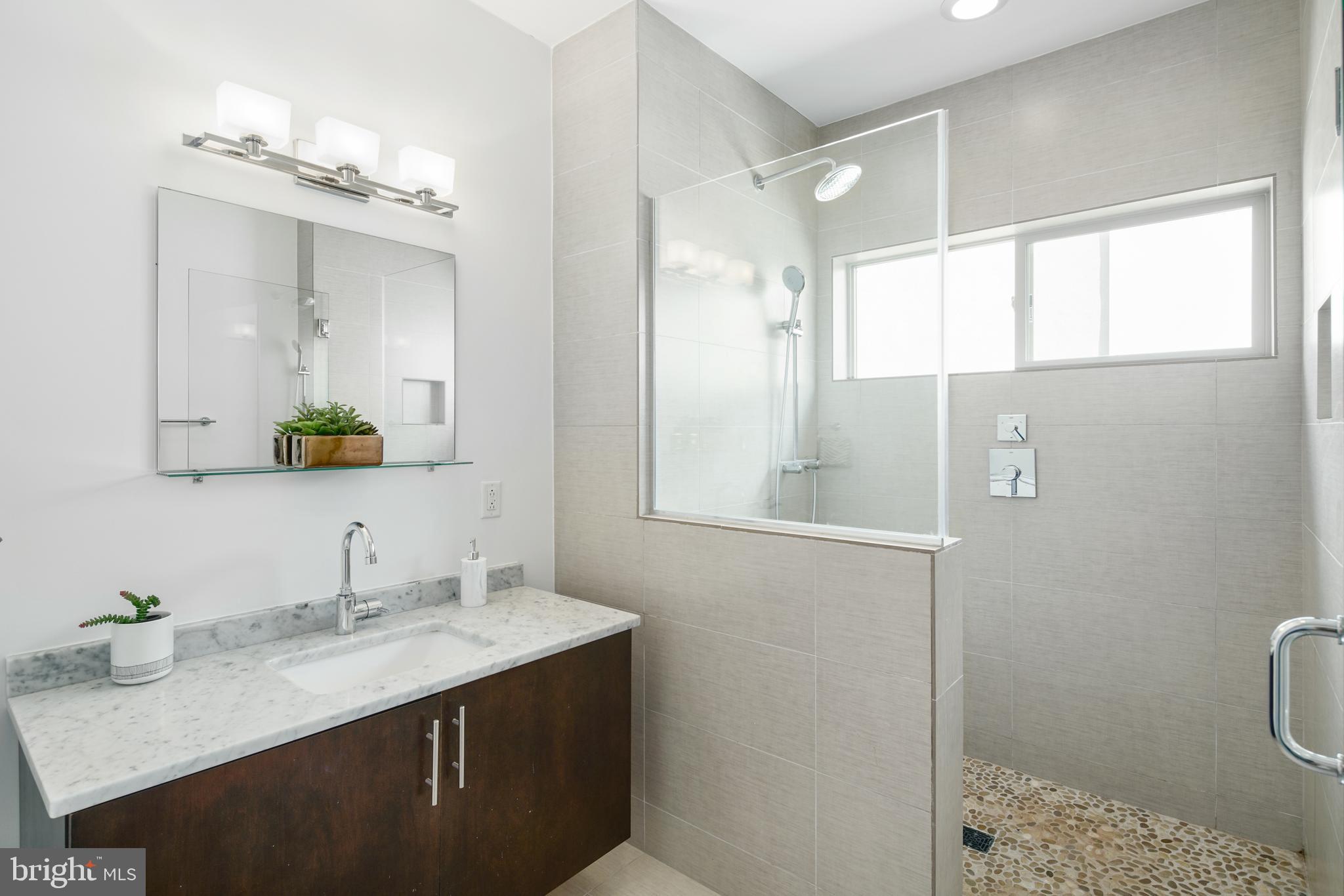 1135 Hope Street, Unit 18 Philadelphia, PA 19123 - Photo 14 of 21 a bathroom with a sink a toilet and shower