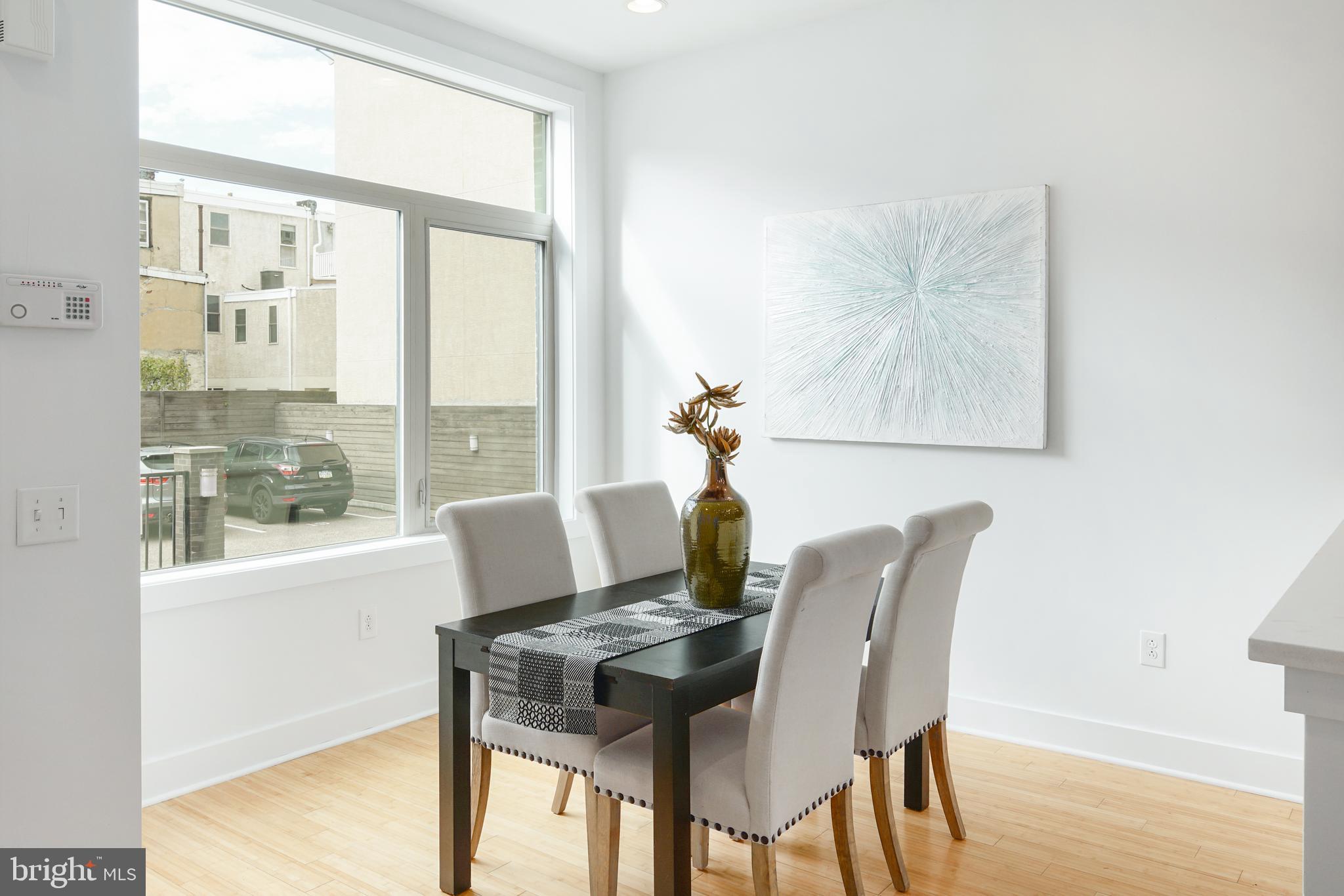 1135 Hope Street, Unit 18 Philadelphia, PA 19123 - Photo 2 of 21 a view of a dining room with furniture and wooden floor