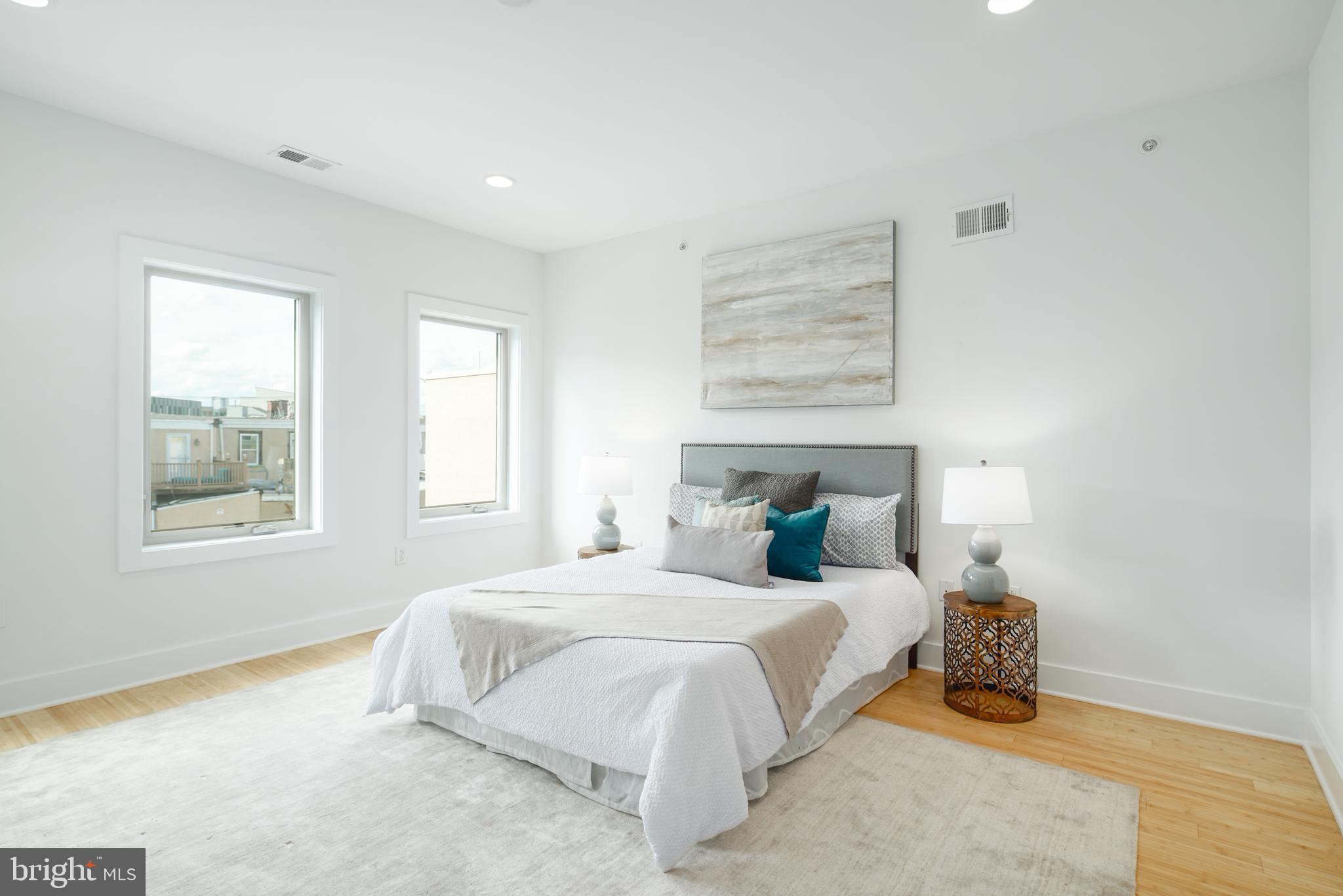 1135 Hope Street, Unit 18 Philadelphia, PA 19123 - Photo 8 of 21 a bedroom with a bed and a window