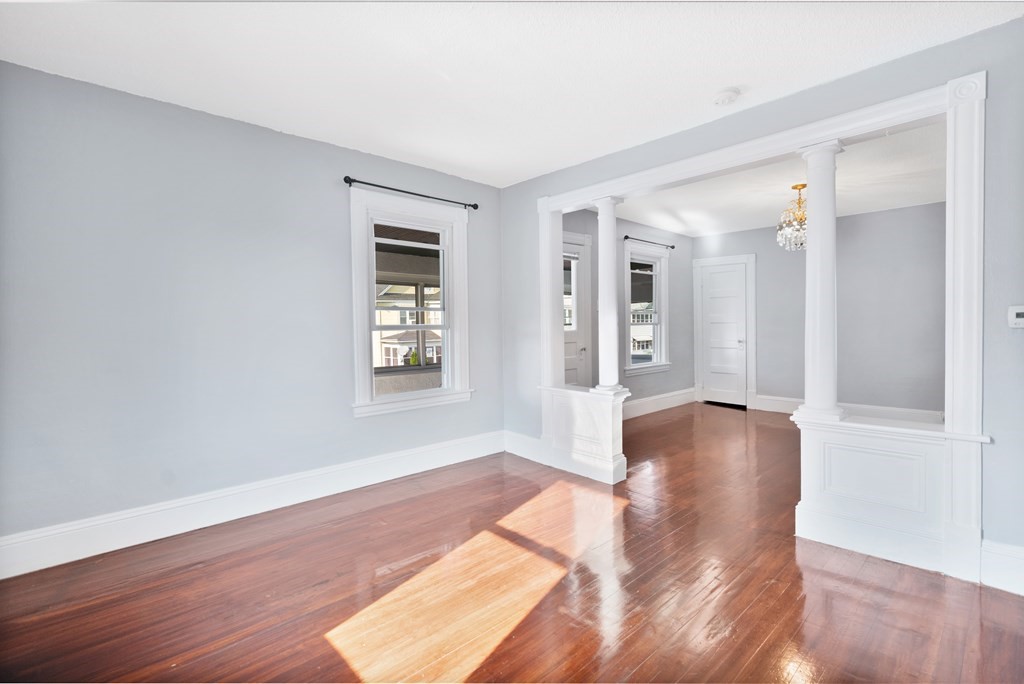 45-47 Quebec Street Springfield, MA 01151 - Photo 14 of 26 an empty room with wooden floor and windows