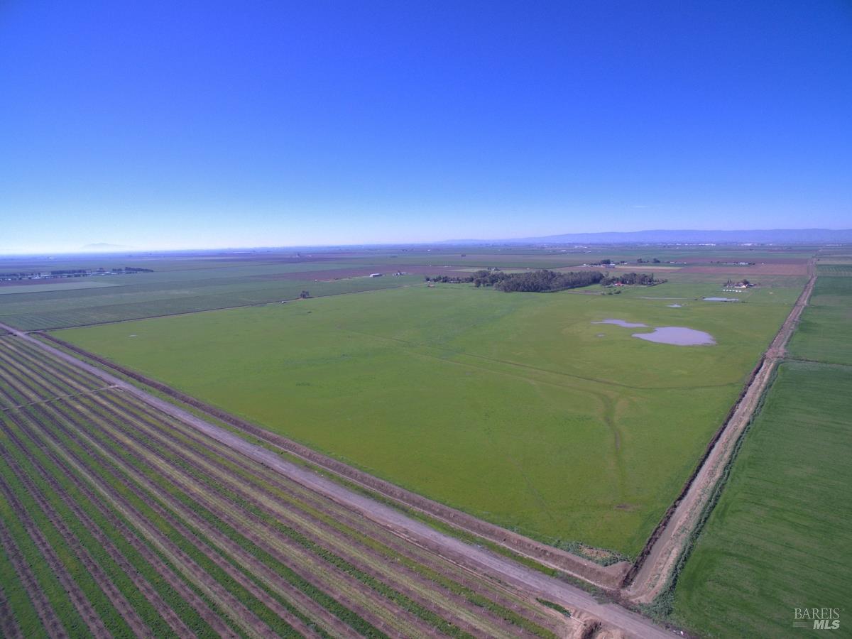 0 Hyde Road Dixon, CA 95620 - Photo 13 of 17 a view of a green field with wooden fence
