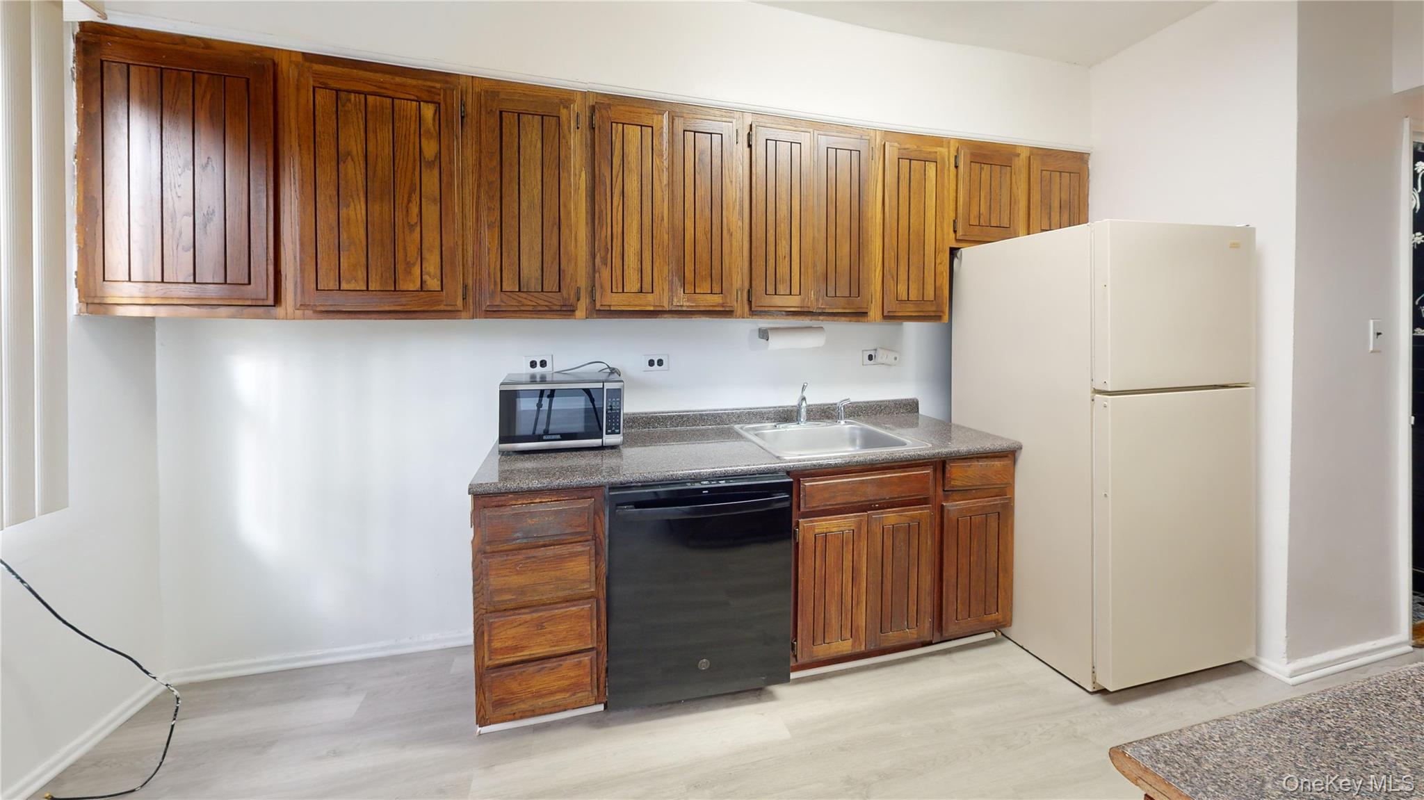 25-40 88th Street Queens, NY 11369 - Photo 2 of 13 a kitchen with a sink and a refrigerator
