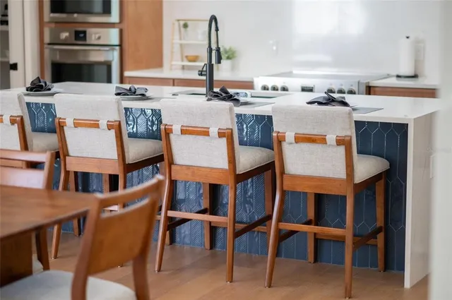 a living room with patio furniture and a potted plant