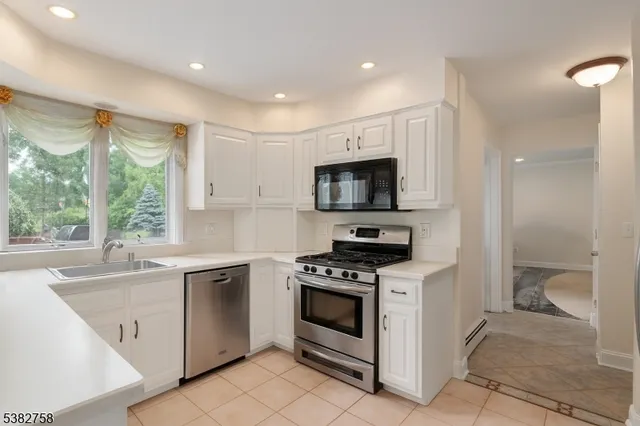 a kitchen with a sink stove top oven and cabinets