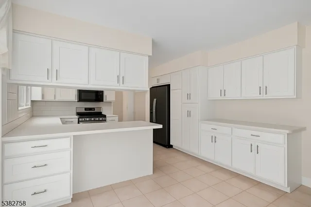a kitchen with cabinets stainless steel appliances and a counter space