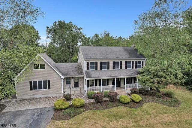 a aerial view of a house next to a yard