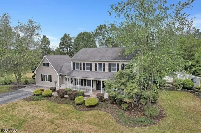 an aerial view of a house with yard and sitting area