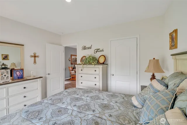 a bedroom with bed and a mirror